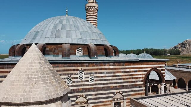 Impressive view of the historic Husrev Pasha Mosque and Tomb in Van. A fine example of Ottoman architecture and stonemasonry. Drone zooms in on the minaret.