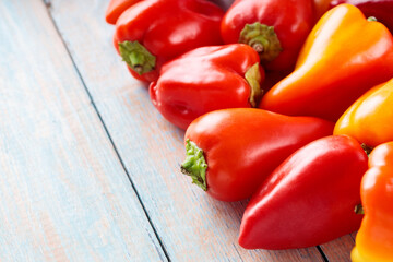 Red and Orange Bell Peppers on Wooden Background for Healthy Farm-Fresh Nutrition, Top View, Copy Space