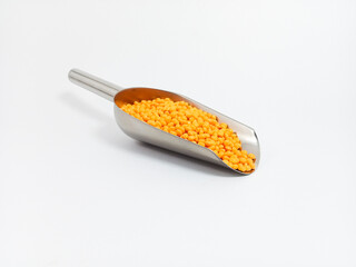 Orange plastic masterbatch, polymer carries colorful pigments with small scoops poured into a white background, suitable for product catalog design of industrial plastic manufacturing company profiles