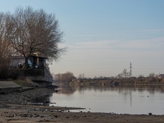 exposed concrete wall of the embankment of the shallow Kuban River near the city of Krasnodar on a...