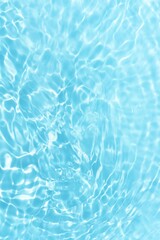 Bluewater waves on the surface ripples blurred. Defocus blurred transparent blue colored clear calm water surface texture with splash and bubbles. Water waves with shining pattern texture background.