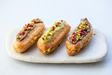 Elegant pistachio and raspberry eclairs