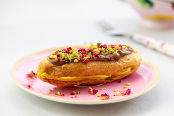 Elegant pistachio and raspberry eclair