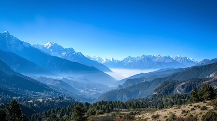 A beautiful view of a mountain range, covered in snow, with a clear blue sky and wispy clouds.