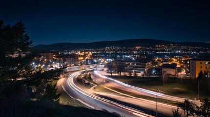 A long exposure shot featuring cars in motion on a road during the night.