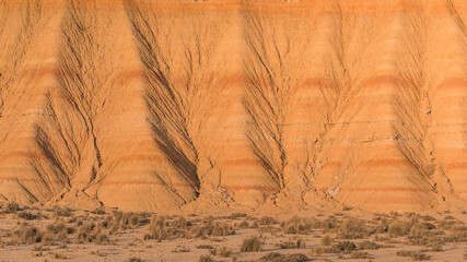 Warm sunset light highlighting the geological formations in the bardenas reales natural park, a semi desert landscape in navarra, spain