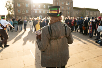 Shallow focus of a female morris dancer seen playing her accordion at a Morris Dancer pageant in...