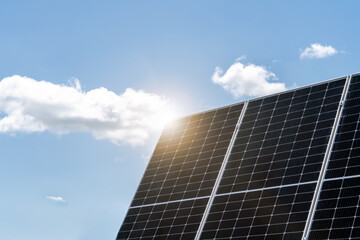 Obraz premium Photovoltaic plant. Solar panel and sunlight against blue sky.