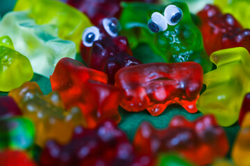 colorful gummy bears in a pile as a background,
