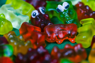 Fototapeta premium colorful gummy bears in a pile as a background,