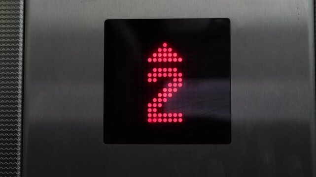 Digital Elevator Display Indicating Movement from First to Fourth Floor with Up Arrow