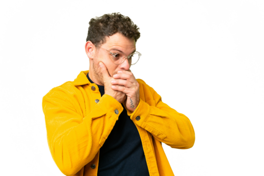 Brazilian man over isolated chroma key background covering mouth and looking to the side