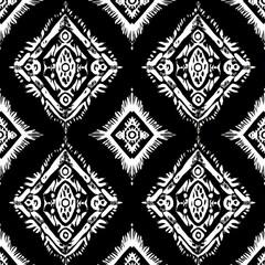 Black and white seamless pattern with Ikat style. The drawing with rhombuses.  Vector illustration