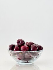 “Fresh Juicy Cherries in a Glass Bowl on a White Background”