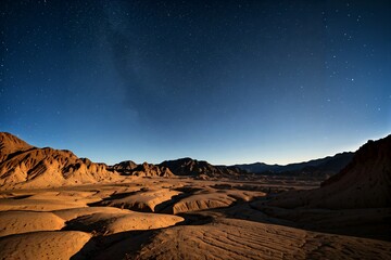 A starry night sky over a desert landscape.