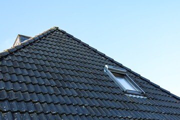 Skylight with External Roller Shutter on a Roof with Black Tiles