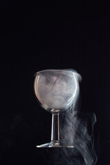 levitating glass full of smoke on a black background