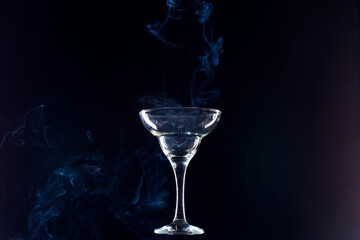 levitating glass full of smoke on a black background