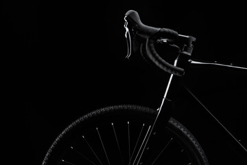 Silhouette of black gravel bike with luminous on black background