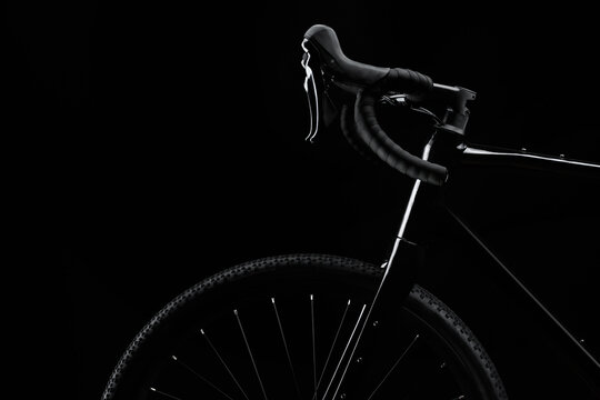 Silhouette of black gravel bike with luminous on black background