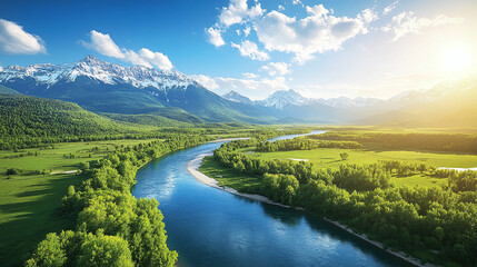 Obraz premium Bird's eye view of a beautiful river between green fields and forests against the backdrop of snow-capped mountains on a sunny day