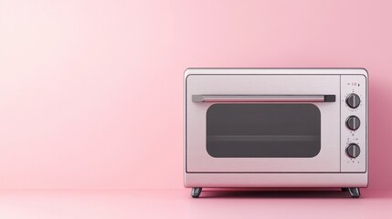 Obraz premium Stainless steel toaster oven on a pale pink backdrop