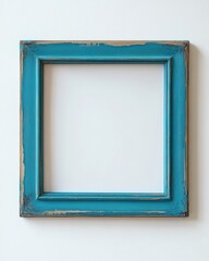 Rustic blue wooden frame on white wall with vintage distressed finish