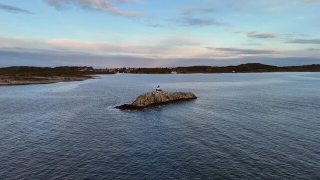 Aerial view of sea mark on the rocky islet of Galten in Sveggevika bay at sunrise