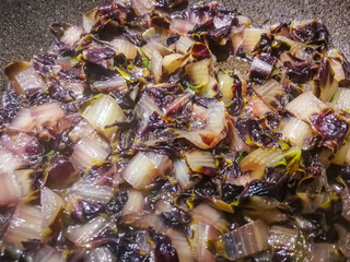 Background with radicchio pieces in pan