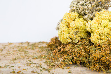 Dried bouquets of hypericum perforatum, immortal flowers and yarrow flowers. Copy space.