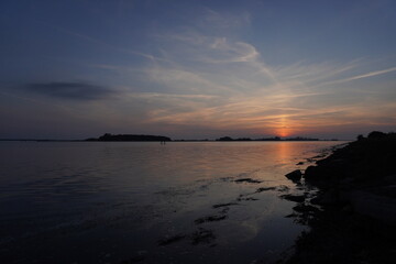 Golden Sunset with Vibrant Sky and Calm Water Reflecting the Light: A Serene Evening Seascape