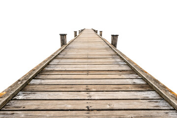 Fototapeta premium A weathered wooden pier stretching into the horizon, supported by sturdy posts, evoking a serene and rustic maritime atmosphere. Isolated on a transparent background