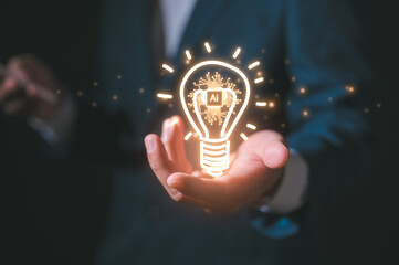 A lightbulb with AI icon floating on hand showing the transfer of innovative ideas Artificial intelligence technology concept with AI