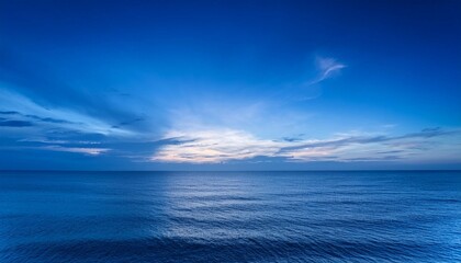 relaxing and bright background of an intense blue sky over a calm sea during the twilight hour