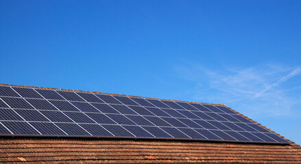 roof with solar panels and blue sky