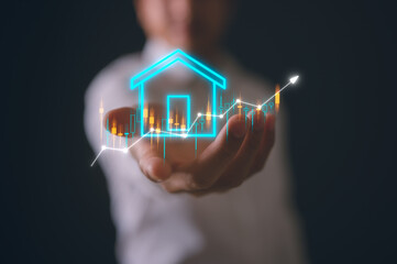 Businessman holding up with virtual real estate and arrow chart real estate investment concept...