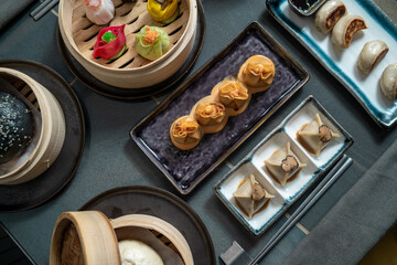 Assorted Gourmet Dim Sum in Bamboo Steamers and Plates - Chinese dining food