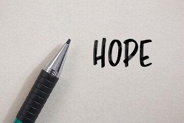 Hope message written on white paper with a pen. Conceptual hope symbol. Copy space.