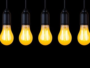 Obraz premium Set of five yellow light bulbs arranged on a white surface for home or office use
