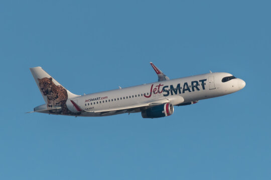an Airbus A320 used by Jetsmart airline flying at sunset on May 23, 2019, over the city of Cordoba, Argentina.