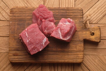 beef on a teak cutting board.