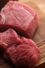 beef on a teak cutting board.