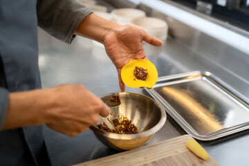Chef preparing dumplings with filling in a professional kitchen - asian food preparation