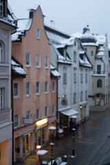 Blurred image of Snow falling - with windows, building on the background.