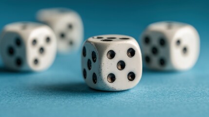 Close-up of white dice showing black dots, arranged on a blue surface, representing chance and gaming.