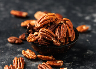 Pecan nuts in a bowl on a rustic table