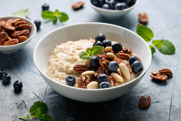 Oatmeal porridge with blueberry, almonds, and pecan healthy food breakfast.