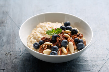 Oatmeal porridge with blueberry, almonds, and pecan healthy food breakfast.