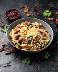 Warm barley pearl salad with kale, dried cranberries, apples and roasted pecan nuts. Healthy food