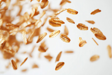 Floating healthy nutrition and diet oatmeals against white background.